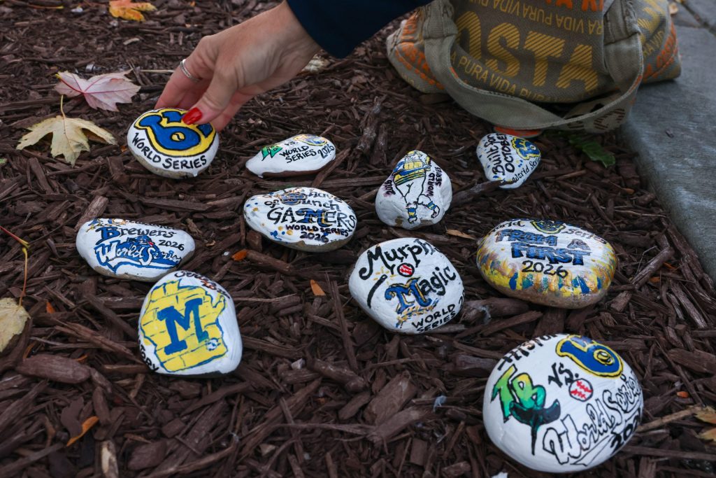 Michelle Gygax lays down a hand-painted rock, part of her ongoing project titled Sam’s Rocks WI, on Oct. 21.