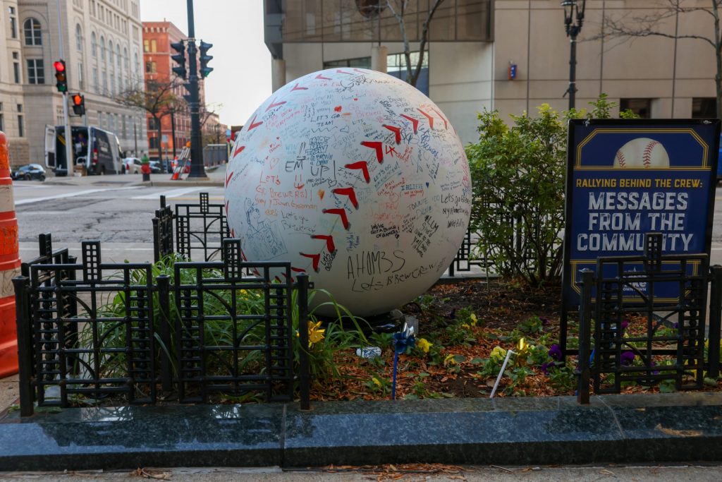 A baseball sculpture covered in signatures and messages from Milwaukee Brewers fans sits in front of the Pfister Hotel, 424 E. Wisconsin Ave.