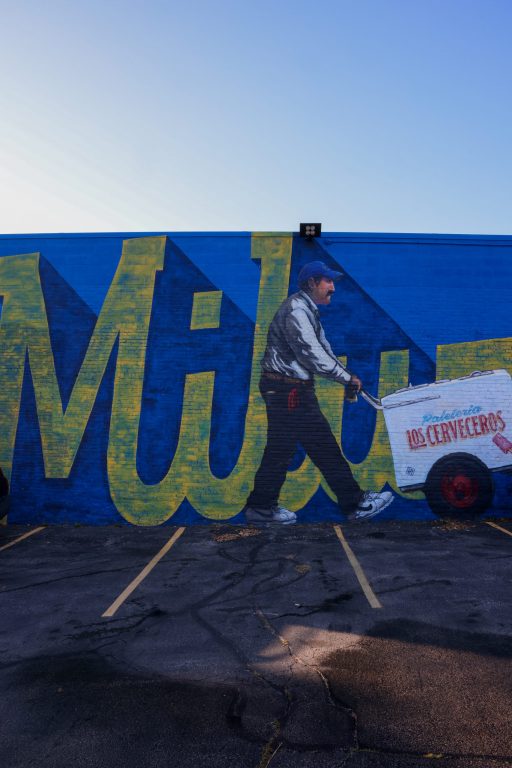 “El Paletero,” a mural painted by Michael Cerda, on the side wall of Heavy Hitters Athletic Facility.