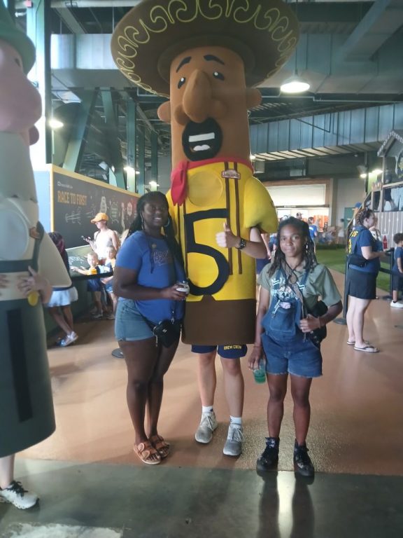 Ryeshia Farmer (left) and a fellow fan pose with the racing Chorizo. (Photo provided by Ryeshia Farmer)