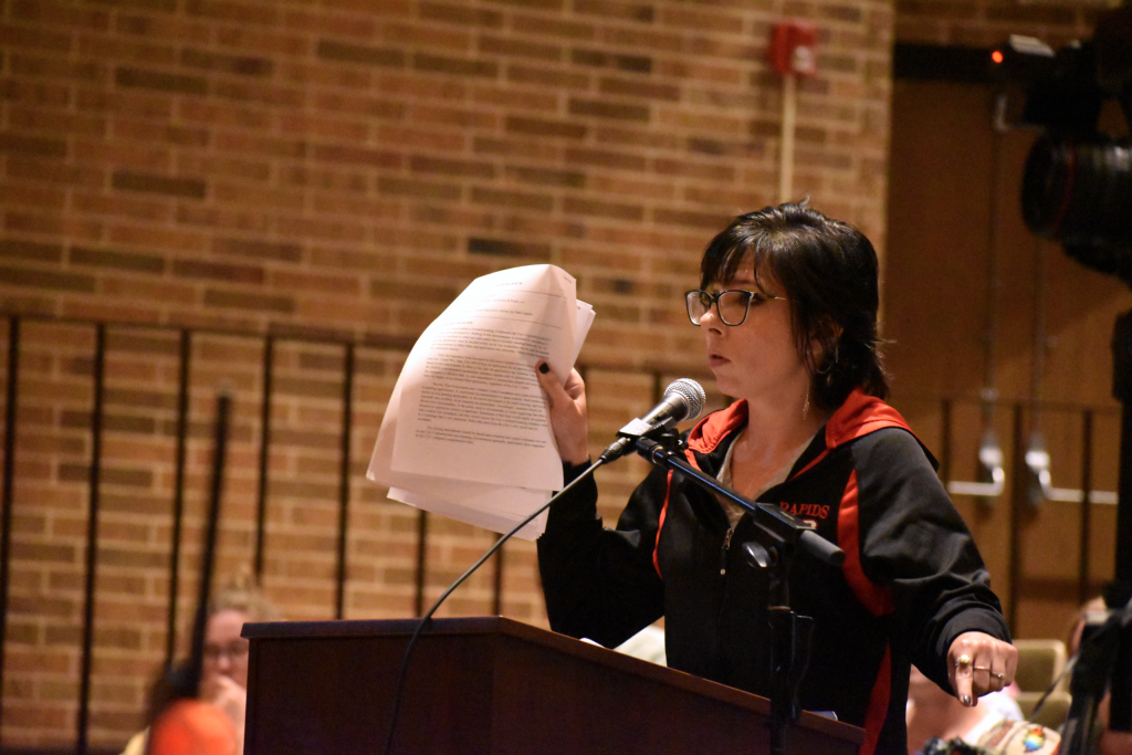 Kaitlyn Federwitz, a Wisconsin Rapids resident, speaks about her strong opposition to a data center proposal in the small community. Her demand for a moratorium was met with thunderous applause. Avery Martinez/ WPR