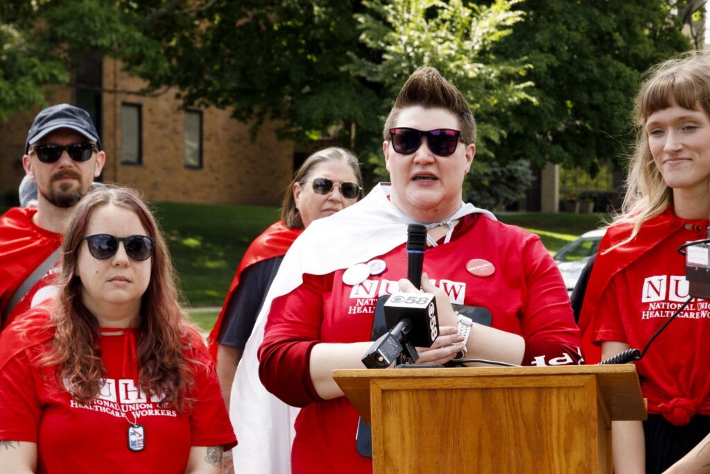 Kate Zolandz, a behavioral health therapist who was fired from Rogers Behavioral Health after actively supporting a union organizing drive, speaks at a rally in June in support of the union. Rogers has been charged with violating federal labor laws in a National Labor Relations Board complaint. (Facebook livestream screenshot)