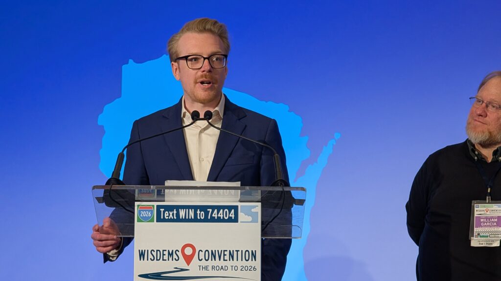 Devin Remiker, chair of the Democratic Party of Wisconsin, speaks at the state party convention on June. On Friday, Oct. 9, the state party sued President Donald Trump and three Trump administration agencies over political ads that the federal government posted in September using taxpayer dollars. (Photo by Baylor Spears/Wisconsin Examiner)