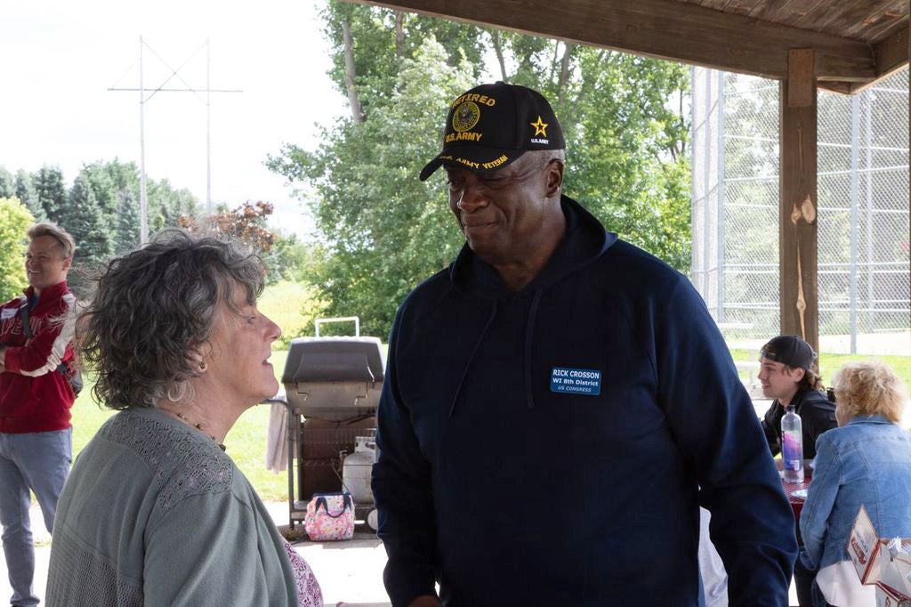 Democrat Rick Crosson, right, speaks with a voter during his campaign for Wisconsin’s 8th Congressional District. Photo courtesy of the Crosson campaign