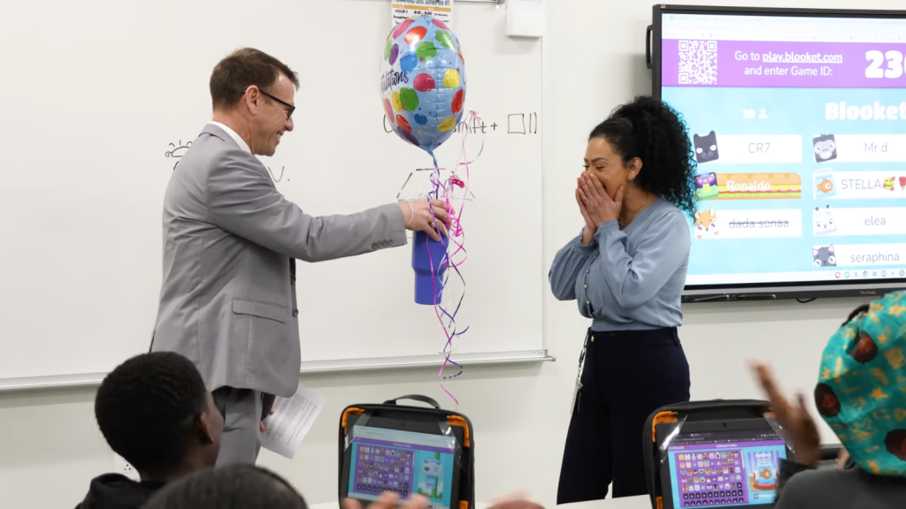Oshkosh Area School District Superintendent Bryan Davis presents Wendy Mendez, right, with an “employee of the year” award in 2025. Source: Oshkosh Area School District YouTube