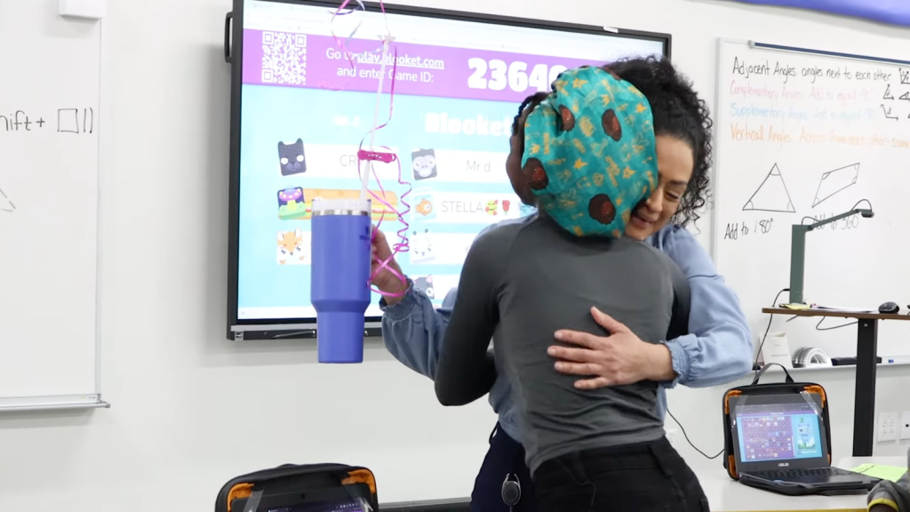 Wendy Mendez, right, hugs a student after receiving an “employee of the year” award from the Oshkosh Area School District. Source: Oshkosh Area School District YouTube