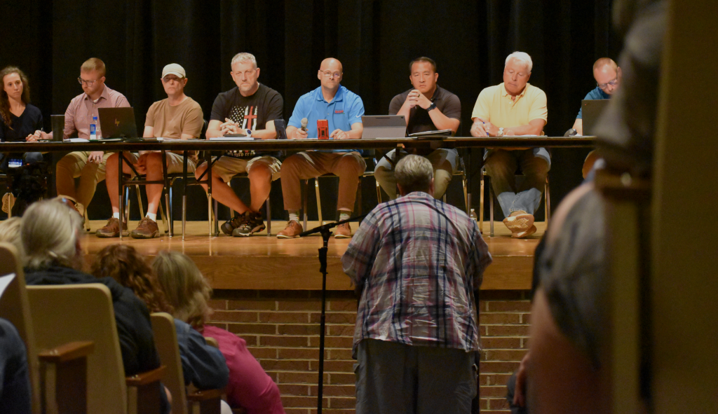 Members of the Wisconsin Rapids Planning Commission look out at the crowd, as local after local stood up to speak firmly against the data center proposal for the small community. Not a single person spoke in support. Avery Martinez/WPR