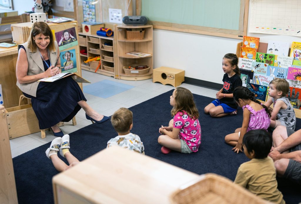 Madison College President Jennifer Berne, left, smiles as she meets with children at the Truax campus Early Learning Campus in July 2025. Madison College had subsidized child care for eligible student parents through the federal Child Care Access Means Parents in School Program. However, officials were notified recently that Madison College did not receive federal CCAMPIS funding. (Courtesy of Madison College)
