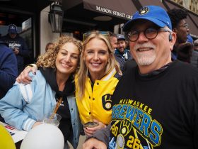 (L to R): Nina Maline, Erin Rogosienski, Mike Hogan got a spot at Mason Street Grill parade watch party. Photo by Lauren Hafeman on Oct. 20, 2026.
