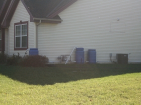Spencer Coggs' home has rain barrels.