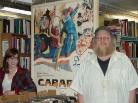 A recent acquisition of a Cabaret poster from its days on Broadway lights up Bay View Books & Music, along with Phie Troka and Dan Dehling.