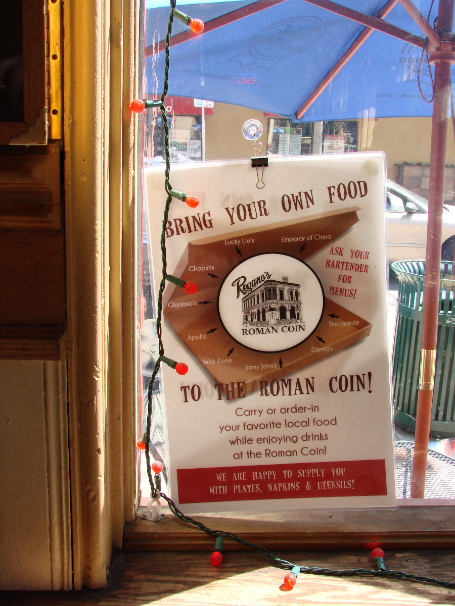 A sign in the window welcomes food from other venues.