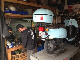 Dez Trow works on one of the scooters brought to Moto-Scoot.