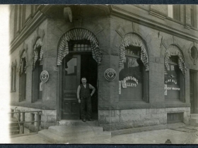 Old picture of a man standing in front of Pabst saloon.