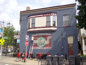 Crews worked Saturday August 10, 2013 to repaint the Nomad World Pub, 1401 E. Brady St.