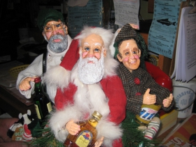 Miniature sculpture showing Joe, Gene and the Ald. Donovan himself with miniatures of their favorite drink.