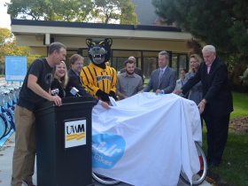 Bublr Bikes executive director Kevin Hardman, UWM chief sustainability officer Kate M. Nelson, county executive Chris Abele, UWM student senator and representative on the Student Transit Committee Dakota Crowell, UWM chancellor Mark Mone, vice chancellor of Finance and Administrative Affairs Robin Van Harpen and Mayor Tom Barrett