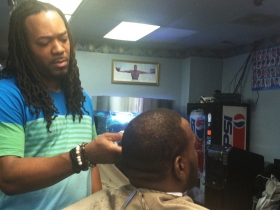 Getting a haircut at Style’s Superior Barber Shop.