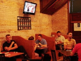 The booths with cream city bricks in back.