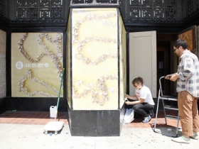 Listening to Mitchell installation on the doors to Schusters.