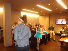 A momentary distraction draws smiles from the models as they prepare for Fashion Week MKE at Spin Tavern.