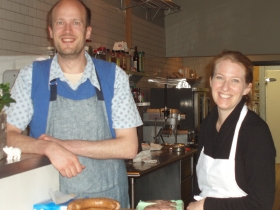 Ed Jurken, customer service, and Karen Bell, owner, combine a warm welcome to customers with plates full of fresh sausages.