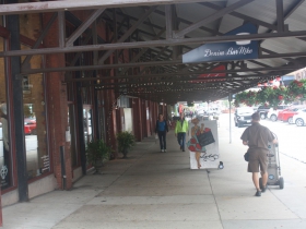 The awning of Commission Row protect diners and shoppers today.
