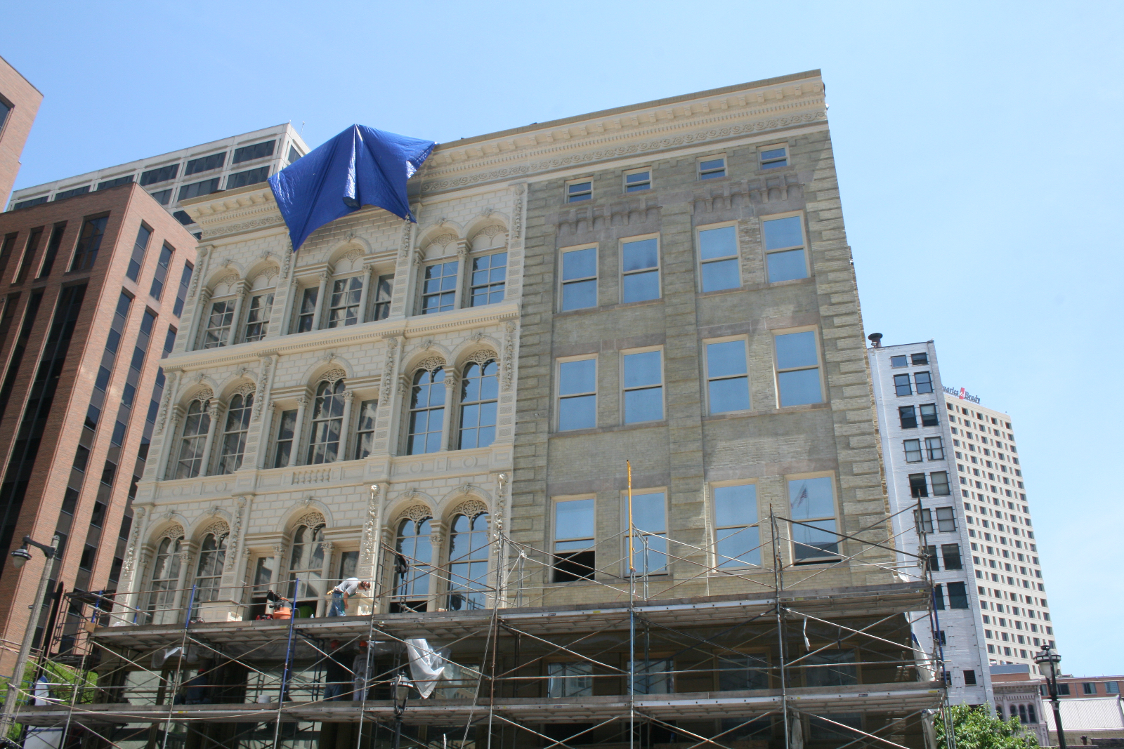Construction workers putting finishing touches on the Iron Block Building.