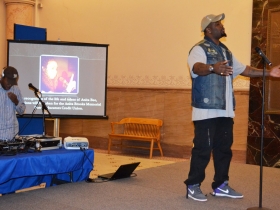 Milwaukee poet shares a piece with a full room.