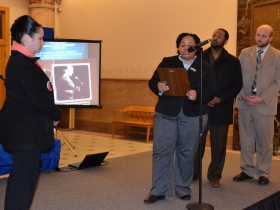 Alderwoman Coggs, Alderman Hamilton, and Alderman Kovac present Anita Bee's Aunt with a proclamation in memory of her niece.