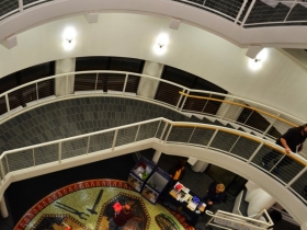 WMSE collected food donations for the Hunger Task Force on the tiled ground floor of the Grohmann Museum Rotunda