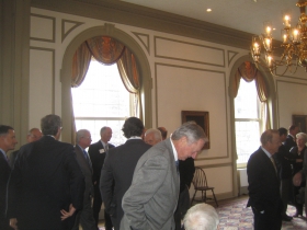Developer Gary Grunau (c) bends over to converse with a seated friend at the Greater Milwaukee Committee's meeting on Downtown Development held at the University Club, Monday, January 13th, 2014. [Photograph taken Monday, January 13th, 2014 by Michael Horne.]