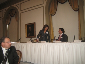 Rick Barrett (r) welcomes Sandy Botcher of NML to the dais while Rocky Marcoux (l) looks on. [Photograph taken Monday, January 13th, 2014 by Michael Horne.]