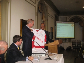 GMC Chair John Daniels (r) presents a Wisconsin Badgers Hockey jersey signed by coach Mike Eaves to Canadian, and hockey fan, Bill Downe, CEO of BMO Harris Financial at the monthly meeting of the GMC held at the University Club Monday, November 10th, 2014.