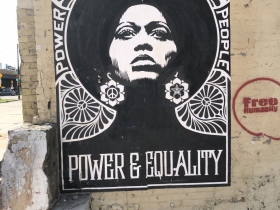 Shepard Fairey Power & Equality poster and a tag by Free Humanity on a building at 320 E. Clybourn St.
