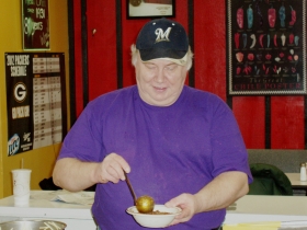 James Stocks adds meat sauce to a serving of spaghetti.  Photo by Peggy Schulz.