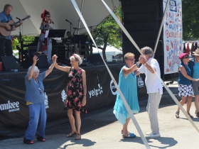 People dance to Robin Pluer at Bastille Days