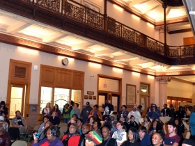 The audience watched performers from the City Hall atrium