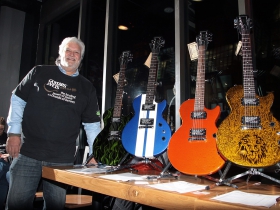 Volunteer, Ron Vianes with donated guitars at the