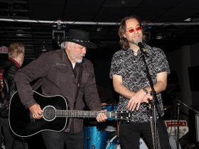 Patrick Nettesheim introduces the headliner, Sam Llanas and his band