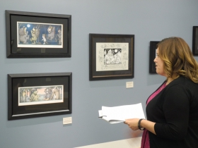 Librarian Christina Gomez giving a tour of the exhibition.