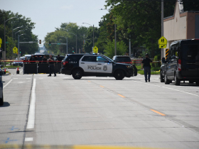Police on W. Vliet Street With Curtain Around Body