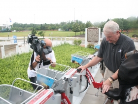 Mayor Barrett unlocks a b-cycle.