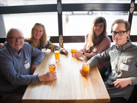 Members socialize as they partake in refreshments provided by Good City Brewing.