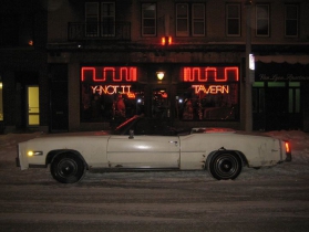 An open-top touring sedan by the Cadillac Motor Company is the perfect conveyance for a Christmas Night visit to the Y-NOT II.