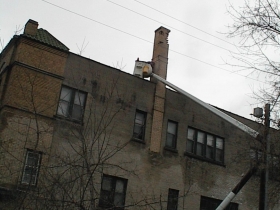 Jenga-style chimney, being rebuilt (in a hurry) by Holton Brothers.
