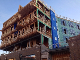 Looking up at the unfinished Prospect Mall Apartments.