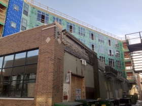 A view of construction of Prospect Mall Apartments from the alley.