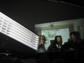 While the fixed projector plays its scene on the north wall of the gallery, the rotating projector spins toward the viewer in this image.