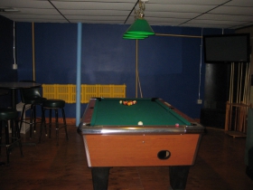 A Mondrian-esque palette awaits players in the pool room. Note the bright yellow radiator, and to its right, a very old fireplace, perhaps dating to the space's use as an 1880's bakery.